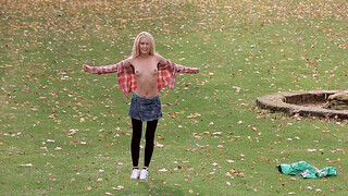 Playful miniature blonde is getting naked on the grass